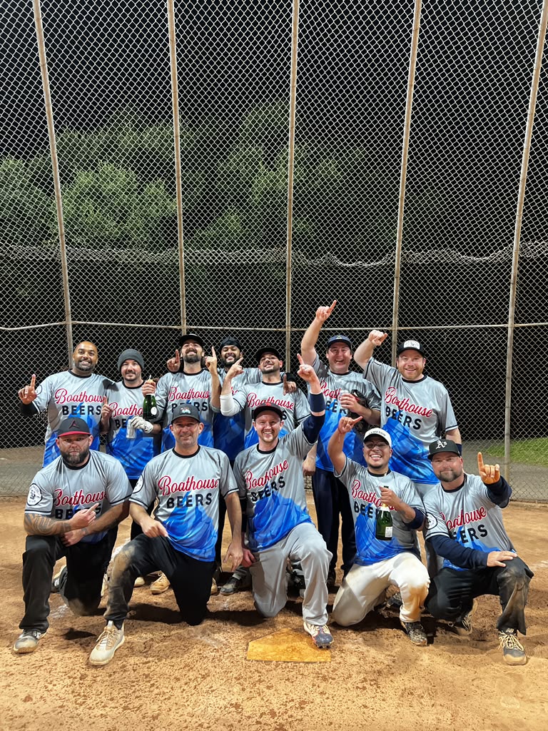 The Boathouse Beers team celebrating their 2026 championship on the softball field